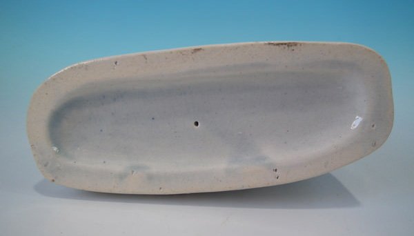 19th century Staffordshire figure base showing viscous blue glaze coming up and onto the footrim.