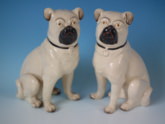 Pair Staffordshire legs free seated pugs