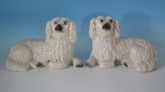 Pair Staffordshire recumbent white&gilt spaniels