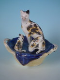Staffordshire cat with kittens in basket