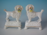 Pair Staffordshire flower basket poodles