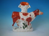 Staffordshire 'MILK SOLD HERE' cow spill vase
