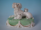 Staffordshire poodle with pups on cushion