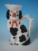 Staffordshire black & white spaniel with bow pitcher