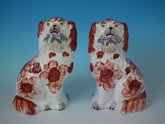 Pair Staffordshire pottery flower basket spaniels