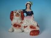 Staffordshire pottery figure of a Girl on Spaniel's back