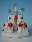 Staffordshire pottery spaniels under a tree group