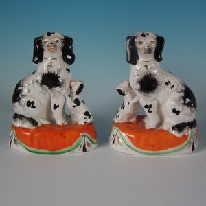 Pair Staffordshire Pottery Spaniels with Pups on Cushions