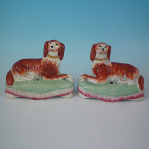 Pair Staffordshire spaniel on cushion inkwells