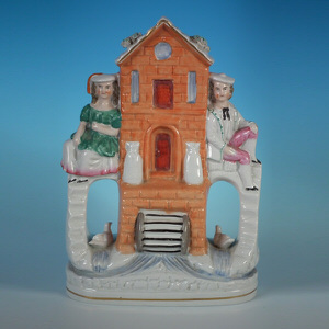 Staffordshire pottery group of a couple & watermill