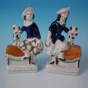 Pair Staffordshire pottery children with begging dogs