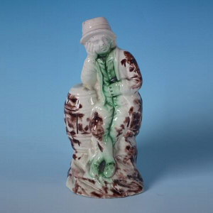 Staffordshire creamware boy on barrel figure