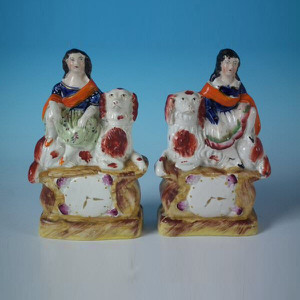 Pair Staffordshire pottery children with spaniel clock groups