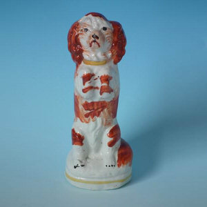 Small Staffordshire pottery begging spaniel figure