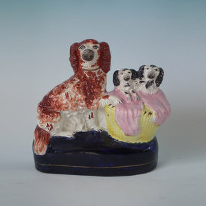 Staffordshire spaniel & pups in wash basket figure group