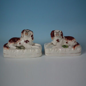 Pair Staffordshire recumbent spaniel inkwells