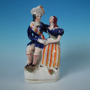 Staffordshire seated couple holding hands