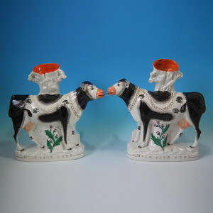 Pair Staffordshire 'Milk Sold Here' cow spill vases