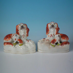 Pair Staffordshire recumbent spaniel with pup figures