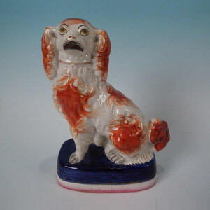 Rare Staffordshire spaniel seated on cushion base