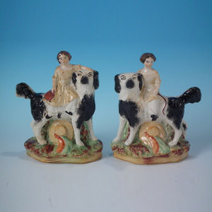 Pair Kent Staffordshire child on spaniel figures