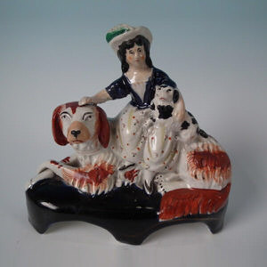 Staffordshire girl on spaniel with puppy figure