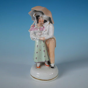 Staffordshire kissing couple under umbrella figure