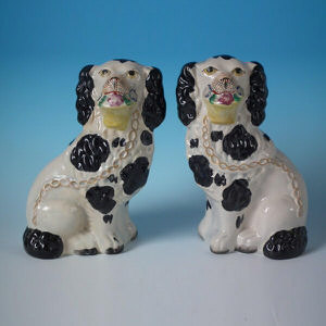 Pair Staffordshire black and white flower basket spaniels