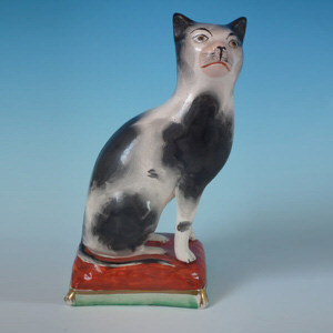 Staffordshire cat on cushion