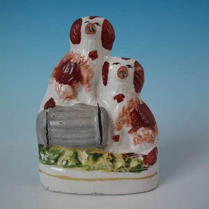 Small Staffordshire spaniels with barrel figure