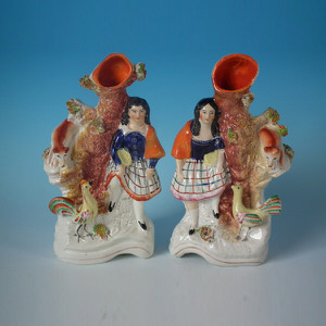 Pair Staffordshire children with fox & hen spill vases