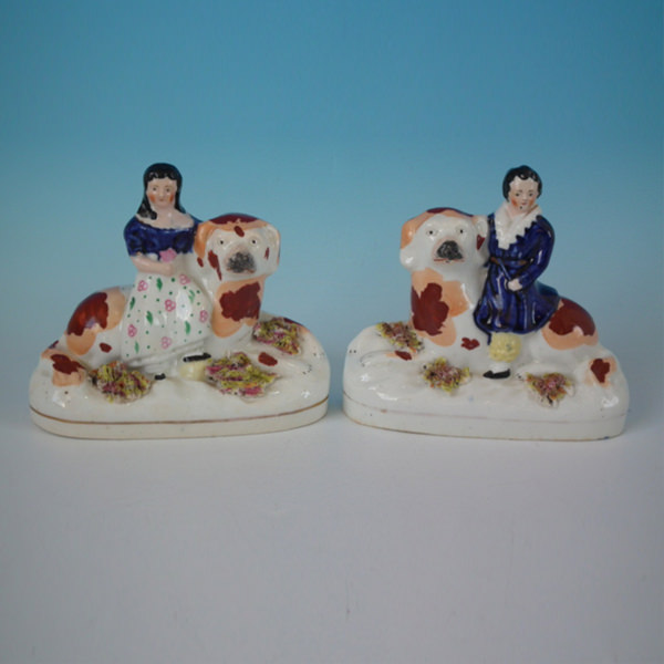 Pair Staffordshire Children seated on recumbent spaniels - ID#20192 Image 1